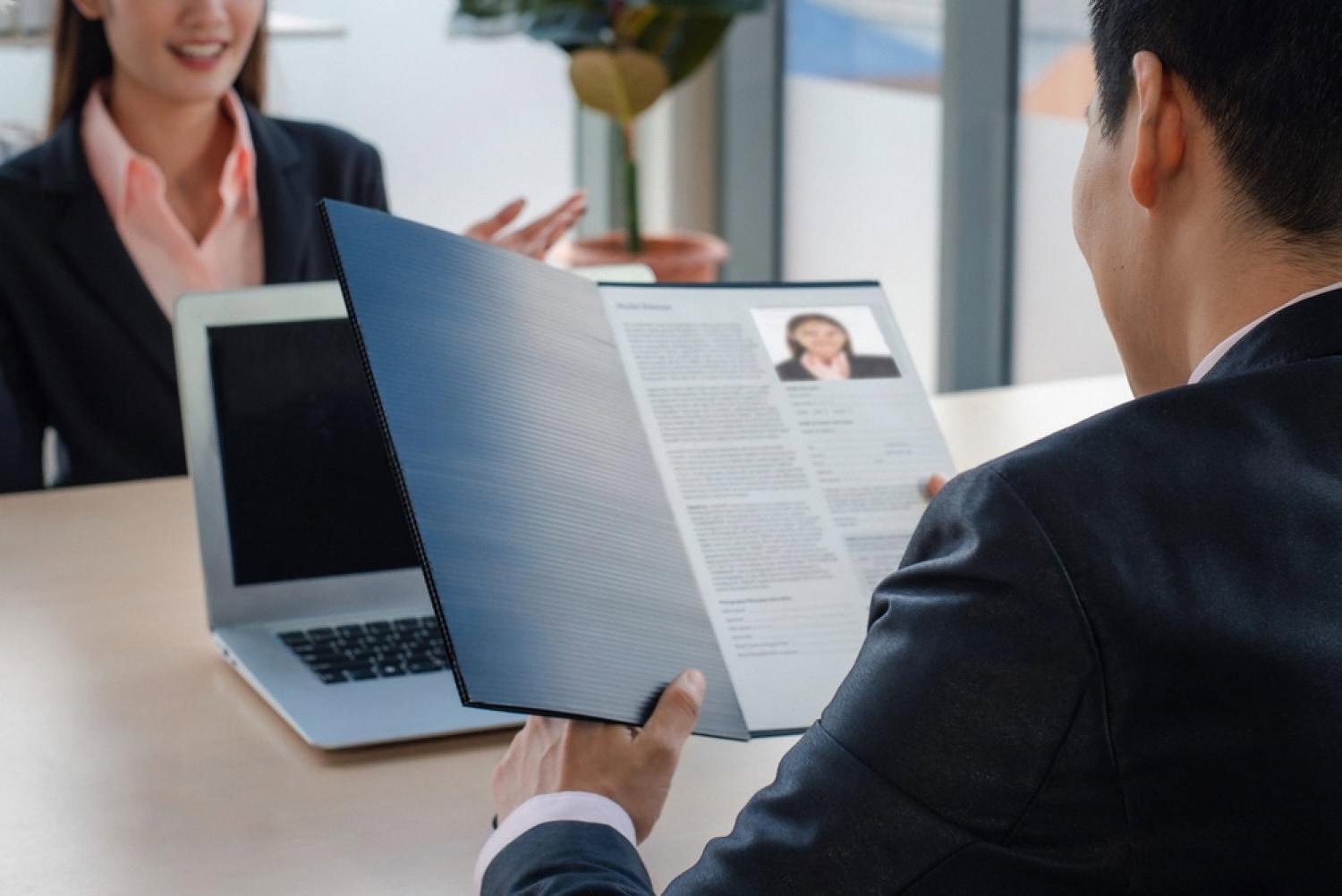 HR specialist reviewing a candidate CV during an HR audit interview in a UAE office